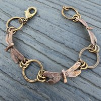 Three Dragonflies copper & bronze bracelet on flat surface, view 2
