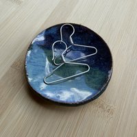Sterling coat hanger earrings in shallow pottery dish
