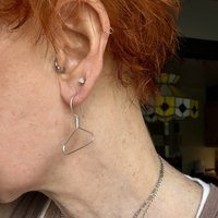 Coat hanger earrings in ear