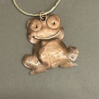 copper frog/toad ornament, gray background