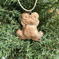 copper frog/toad ornament, christmas tree background