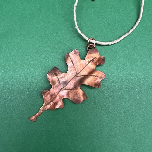 Copper oak leaf ornament green background