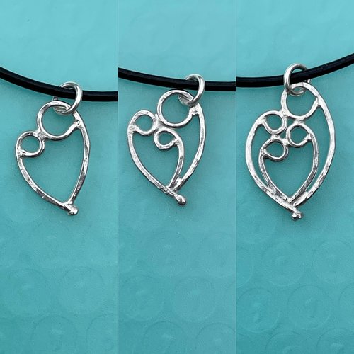 Mother & 1, 2, or 3 child pendant on black cord necklace.
