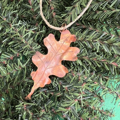 Copper oak leaf ornament on tree