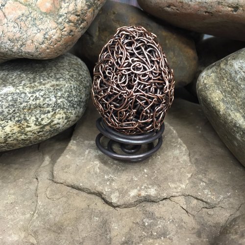 woven copper egg on stand