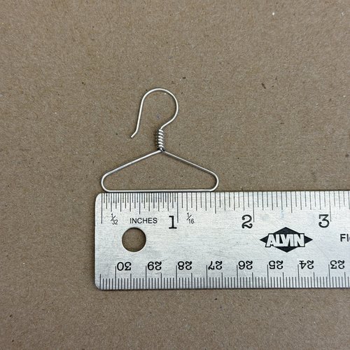 Coat hanger earrings showing width next to ruler