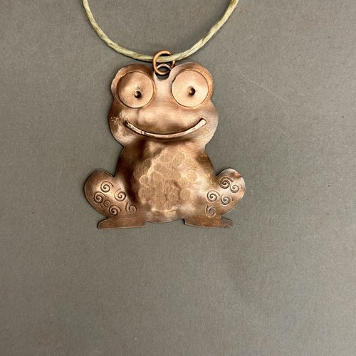 copper frog/toad ornament, gray background