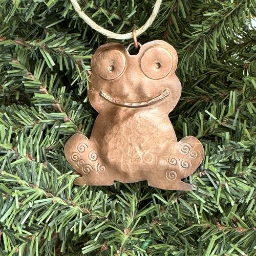 copper frog/toad ornament, christmas tree background