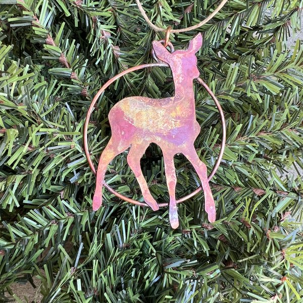 Copper deer fawn silhouette in circle ornament.